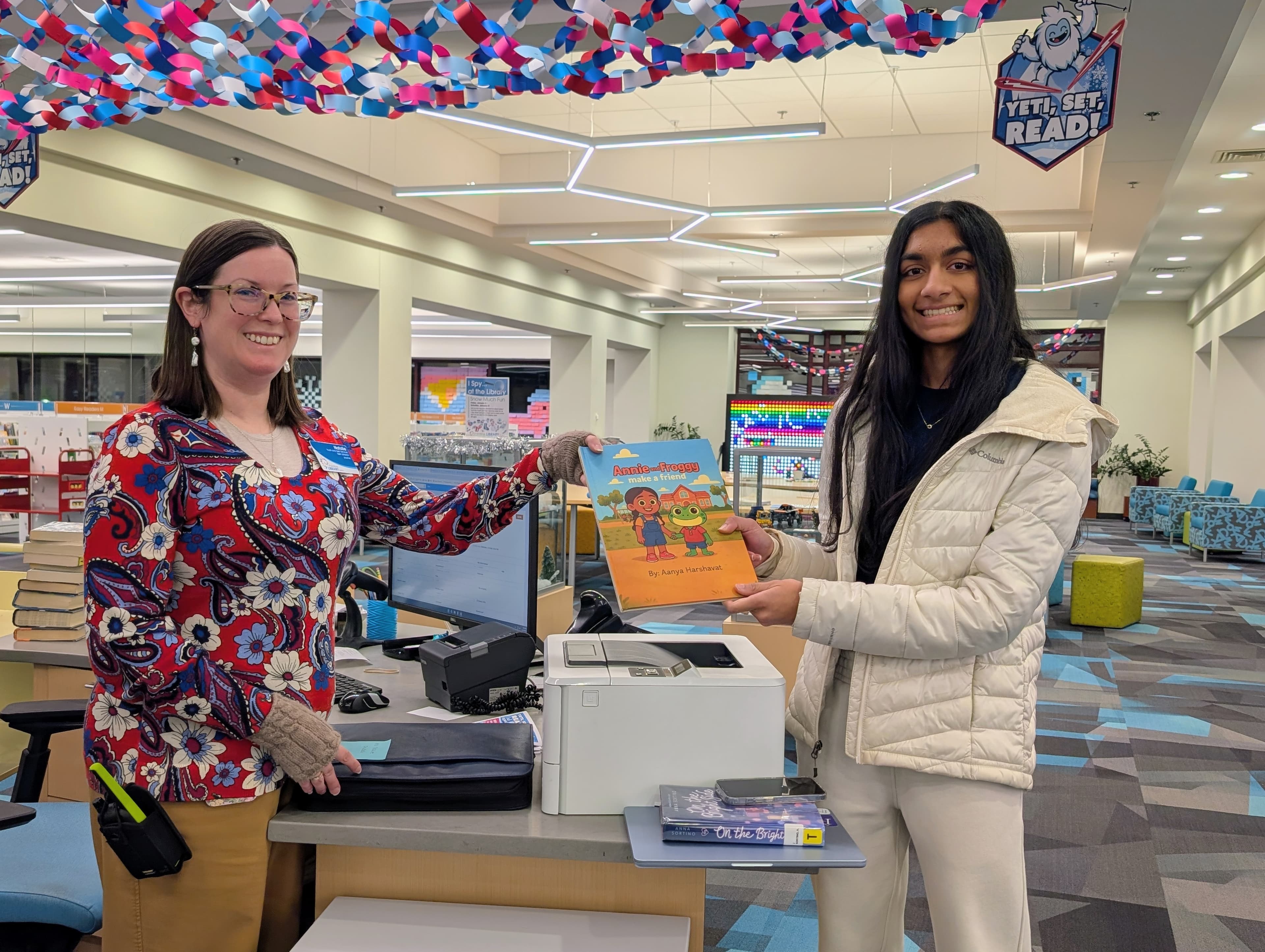 Aanya at the library with her book